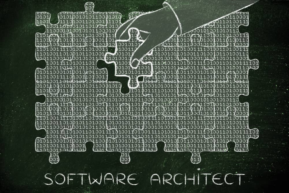Ilustración del "Concepto de arquitectura de software": mano colocando pieza de rompecabezas con código binario. Representación visual de la estructura del software.